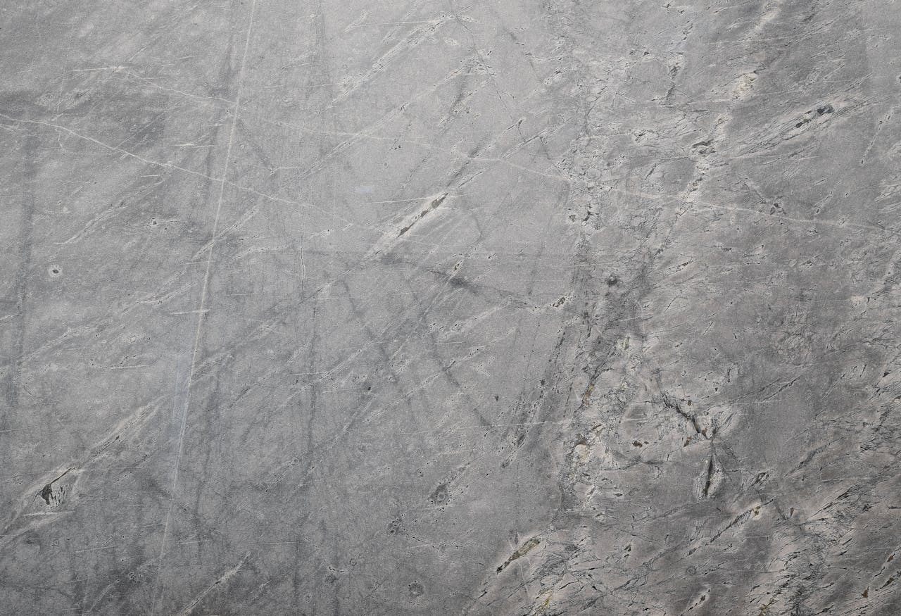Close-up of a textured grey stone surface suitable for backgrounds or wallpapers.